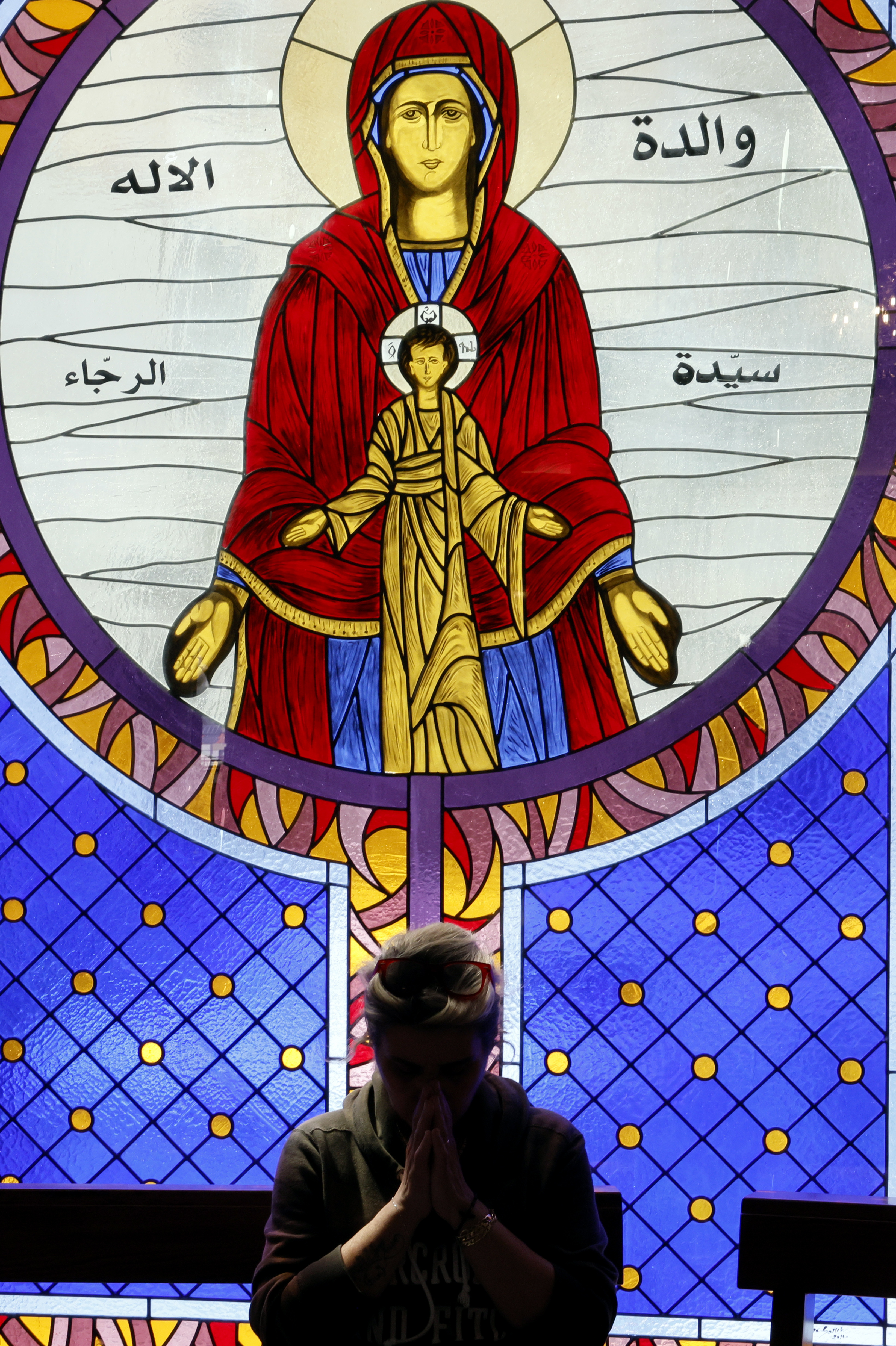 A woman prays during the mass