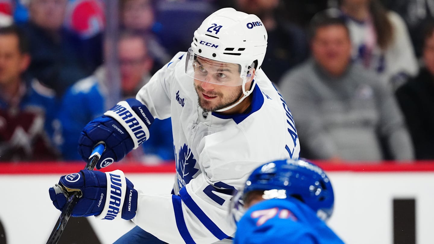 Jan 12, 2026; Denver, Colorado, USA; Toronto Maple Leafs center Scott Laughton (24) takes a shot on goal in the first period at Ball Arena. Mandatory Credit: Ron Chenoy-Imagn Images