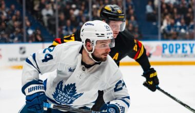 Jan 31, 2026; Vancouver, British Columbia, CAN; Vancouver Canucks defenseman Tyler Myers (57) defends against Toronto Maple Leafs forward Scott Laughton (24) in the third period at Rogers Arena. Mandatory Credit: Bob Frid-Imagn Images