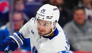 Jan 12, 2026; Denver, Colorado, USA; Toronto Maple Leafs center Scott Laughton (24) takes a shot on goal in the first period at Ball Arena. Mandatory Credit: Ron Chenoy-Imagn Images