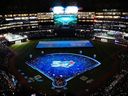 Fans and players watch a pregame ceremony prior to  MLB baseball action between the Toronto Blue Jays and the Athletics in Toronto on March 27, 2026. 