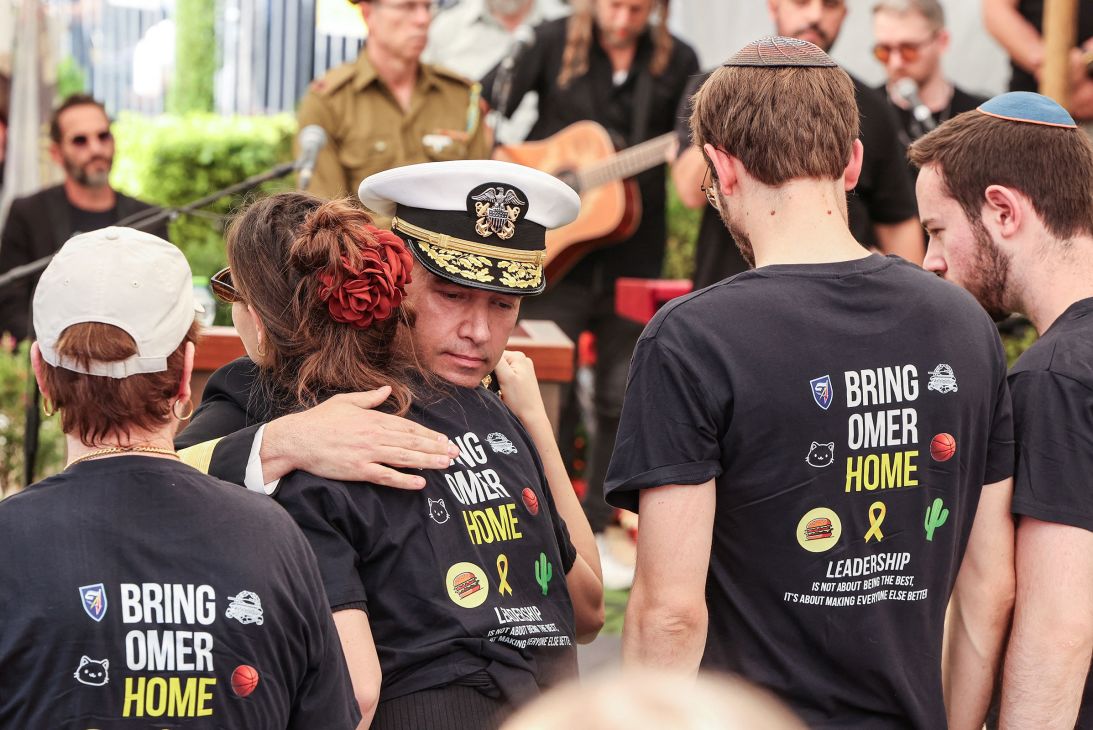 Cooper comforts a relative of Omer Neutra during Neutra's funeral at the Kiryat Shaul Military Cemetery in Tel Aviv, Israel, on November 7, 2025.