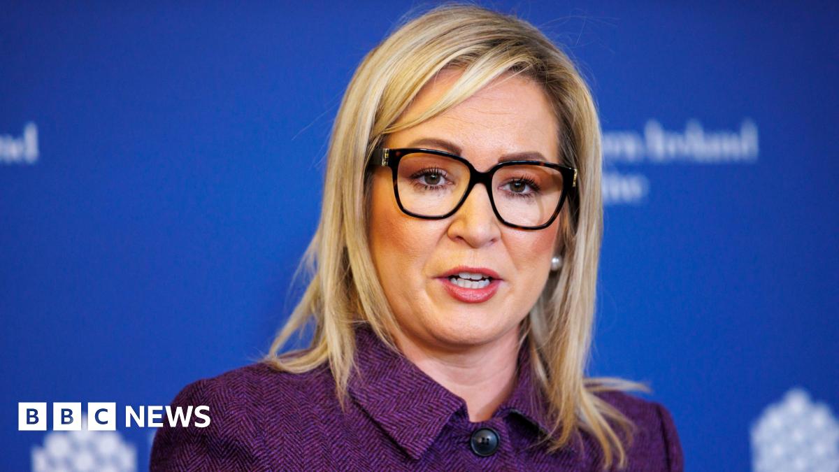 Several vehicles are seen on a multi-lane road in Abu Dhabi as smoke billows from Zayed port in the distance in the left of the picture