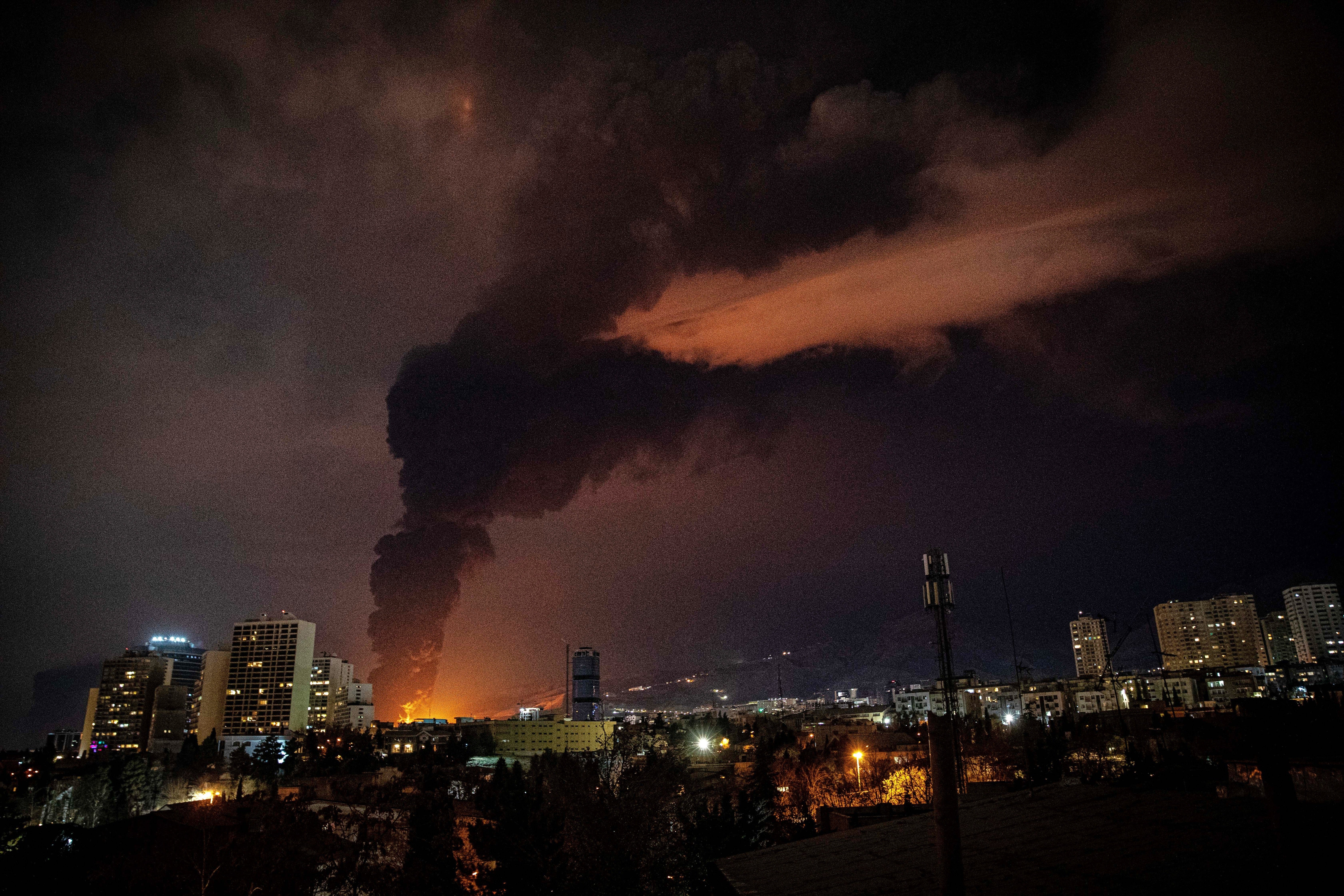 Flames and smoke rise from an oil storage facility in Tehran, Iran (Alireza Sotakbar/ISNA via AP)