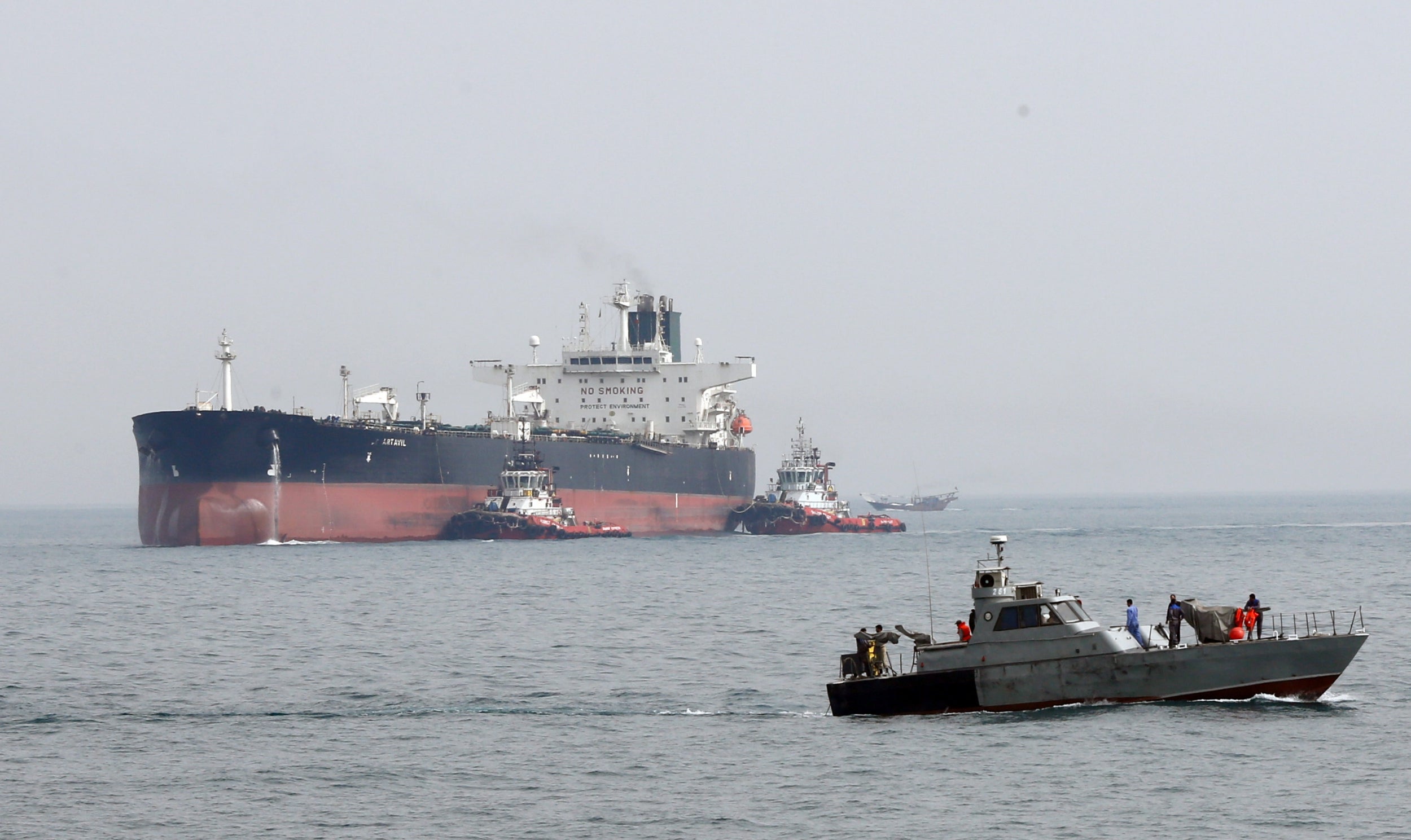 An Iranian military boat patrols next to the Artavil oil tanker, at Kharg Island, in Persian Gulf,