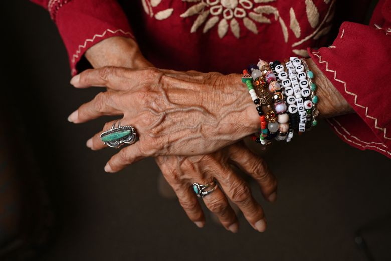 Dolores Huerta, 95, cofounder of the United Farm Workers of America labor union, with bracelets reading 