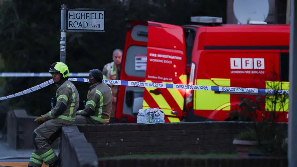 Firefighters gather at the scene in northwest London. - Hannah McKay/Reuters