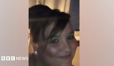 Police issued image of Carolann Barraclough. She is smiling a the camera and has long dark hair piled up on her head