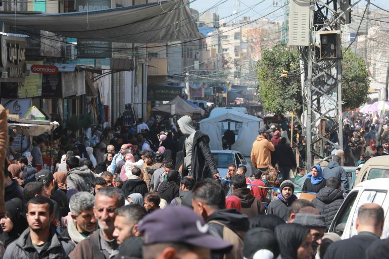 Crowds filled Gaza’s markets as residents rushed to stockpile food after news of the Iran war and the closure of Gaza and West Bank crossings [Abdelhakim Abu Riash/ Al Jazeera]