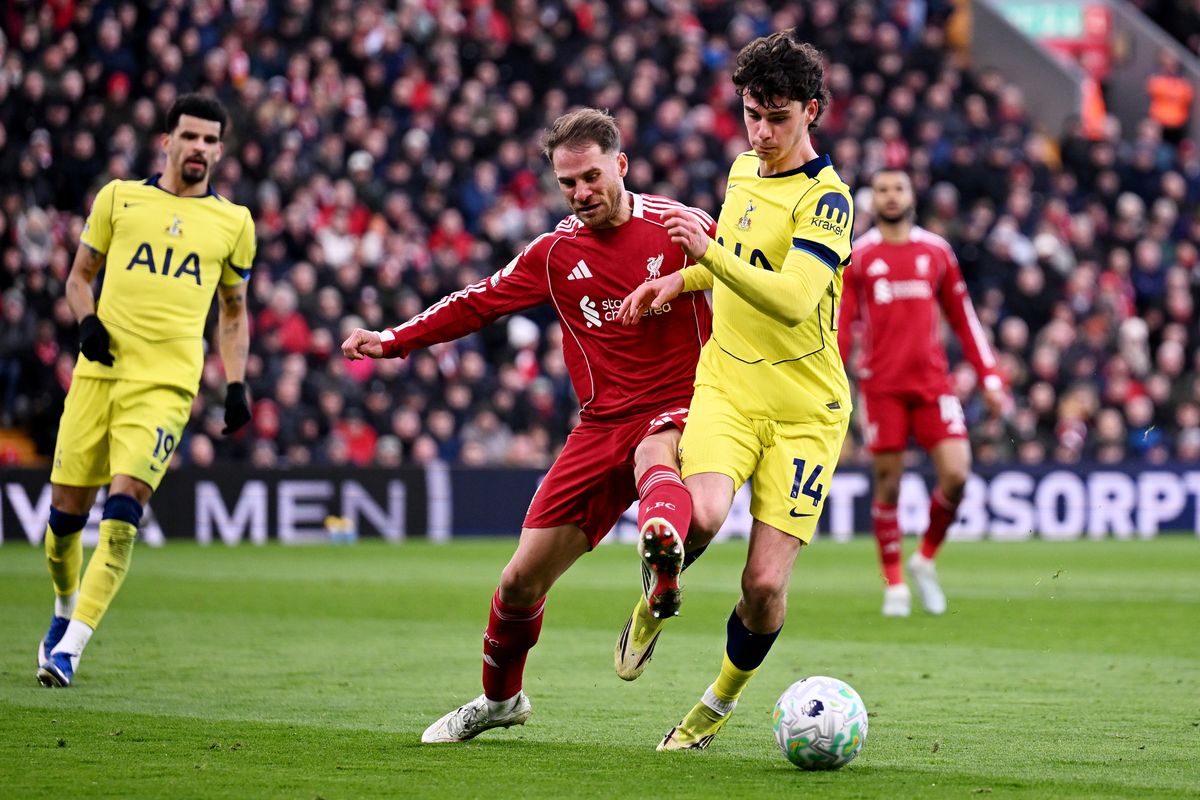 Archie Gray of Tottenham Hotspur is challenged by Alexis Mac Allister of Liverpool during the Premier League match between Liverpool and Tottenham Hotspur at Anfield on March 15, 2026 in Liverpool, England.