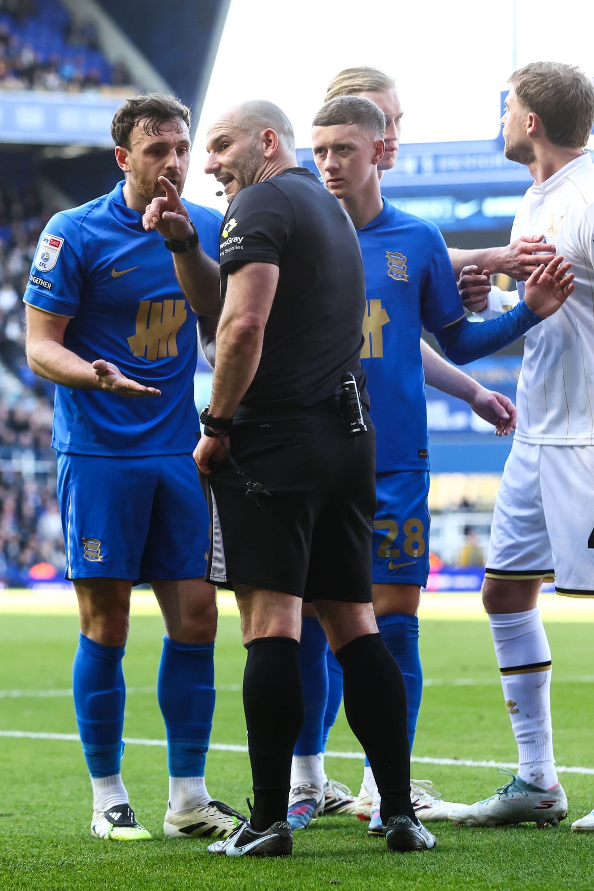 Jack Robinson talks with referee Tim Robinson after a penalty is given against him