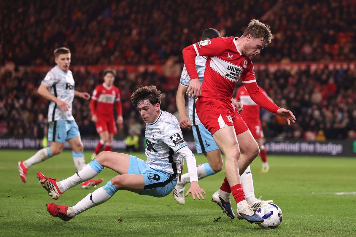 Tommy Conway of Middlesbrough escapes the challenge of Luke Chambers
