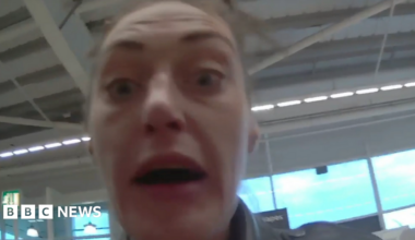 A woman with brown hair and a leather jacket in a still from a body cam