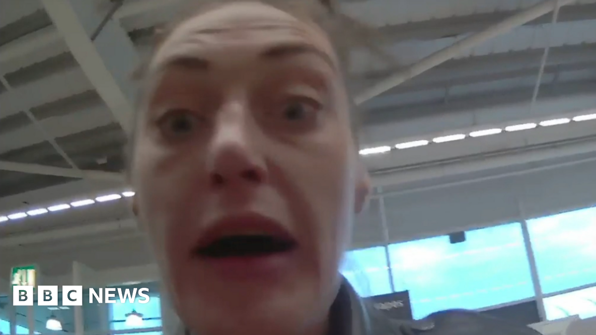 A woman with brown hair and a leather jacket in a still from a body cam