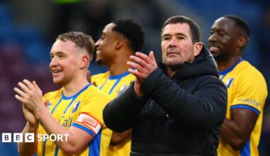 Manager Nigel Clough stands with his players and claps his hand in appreciation after Mansfield beat Burnley in the FA Cup