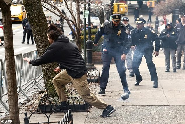 Balat is pictured fleeing after dropping the improvised explosive near police officers. Police initially were unsure if the device was an imitation or a real bomb