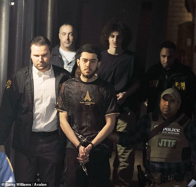 Ibrahim Kayumi (front) and Emir Balat (back) in federal custody leaving the NYPD's 26th Precinct stationhouse in NYC on Monday. They were indicted on five federal charges including attempting to provide material support to ISIS and use of a weapon of mass destruction