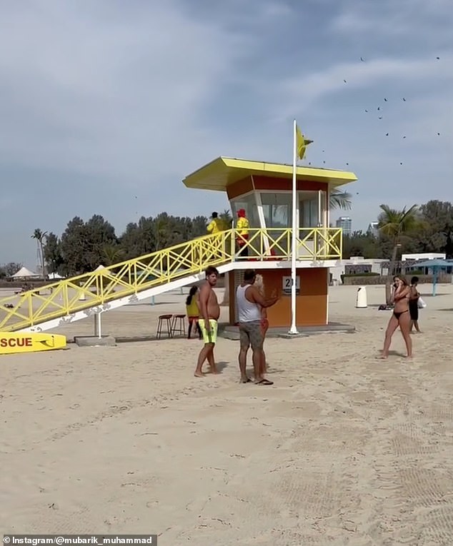 Footage shows shocked beachgoers looking at the sky as the fighter jet chases the drone