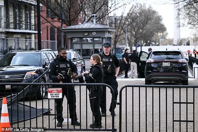 Members of the US Secret Service monitor the scene after a vehicle ran into a security barricade near the White House in Washington, DC, on March 11
