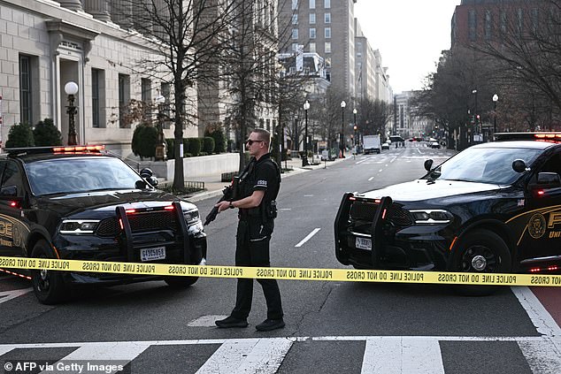 A member of the US Secret Service monitors the scene after a vehicle ran into a security barricade near the White House in Washington, DC, on March 11