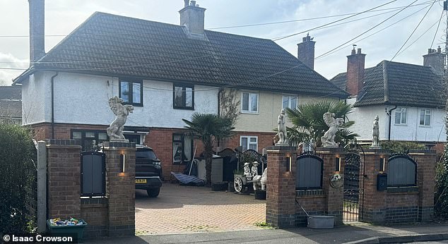 Travellers who crowned the front wall of their semi-detached home with four 'ugly' horse statues have accused 'jealous' neighbours of racism after losing a bitter planning battle