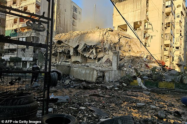 Rubble and debris are strewn across a road at the site of an Israeli airstrike that targeted Beirut's southern suburbs, in the al Kafaat neighborhood, on March 17