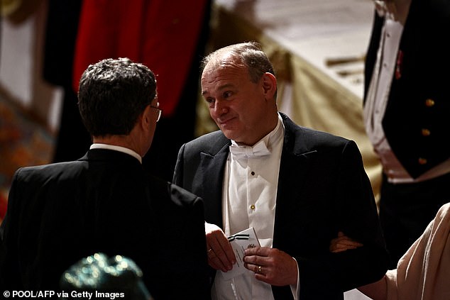 Liberal Democrat party leader Ed Davey speaks to Governor of the Bank of England, Andrew Bailey, during the banquet