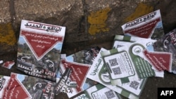 Warning leaflets dropped by the Israeli military over the Lebanese capital, Beirut, litter the street on March 13.