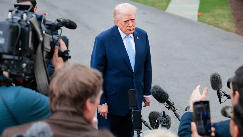President Donald Trump stops to speak to reporters as he departs the White House on March 20, 2026. - Heather Diehl/Getty Images