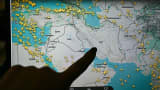 A person points at a page on the Flightradar 24 website thats shows civilian flights avoiding Iranian and Iraqi sky, in Paris on March 1, 2026. 