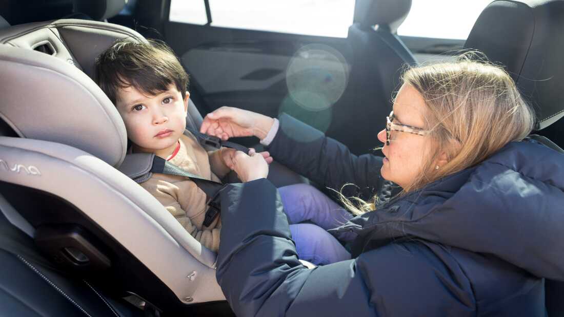 Elizabeth Kanagawa, a certified child passenger safety technician and the owner of Three Littles, a children's store that sells strollers and car seats in Washington, D.C, demonstrates how to adjust the harness of a car seat.