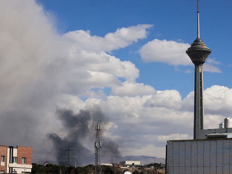 A plume of smoke rises following reported explosions in Tehran on March 1, 2026.
