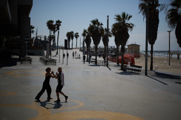 Jack Schneider practices Israeli folk dancing with his partner at the beachfront of Tel Aviv, Israel, Monday, March 2, 2026. (AP Photo/Leo Correa)