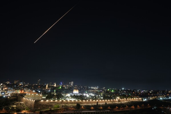 Trace of an air defense missile interception during an Iranian attack is seen over Jerusalem's Old City, Sunday, March 1, 2026. (AP Photo/Mahmoud Illean)