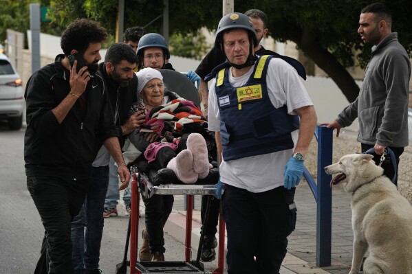 Paramedics evacuate wounded people from the site of a deadly Iranian missile strike in Beit Shemesh, Israel Sunday, March 1, 2026. (AP Photo/Leo Correa)