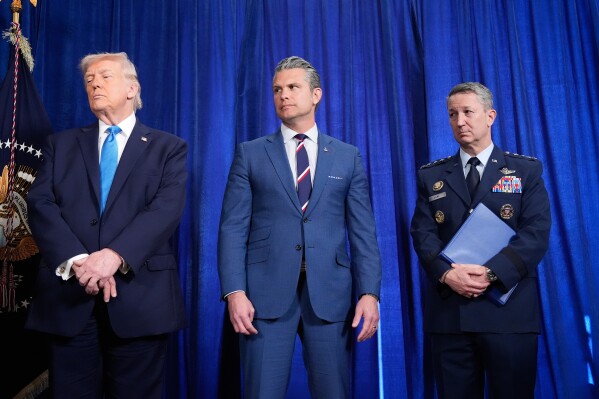 President Donald Trump, Defense Secretary Pete Hegseth and Chairman of the Joint Chiefs of Staff Gen. Dan Caine listen as Secretary of State Marco Rubio speaks during a news conference at Mar-a-Lago, Saturday, Jan. 3, 2026, in Palm Beach, Fla. (AP Photo/Alex Brandon)