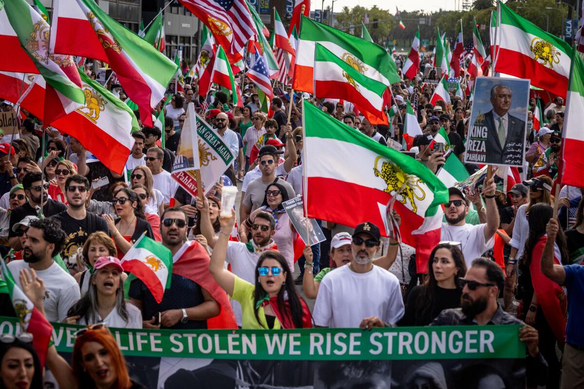 A large number of people celebrate as they march through the streets of Westwood.