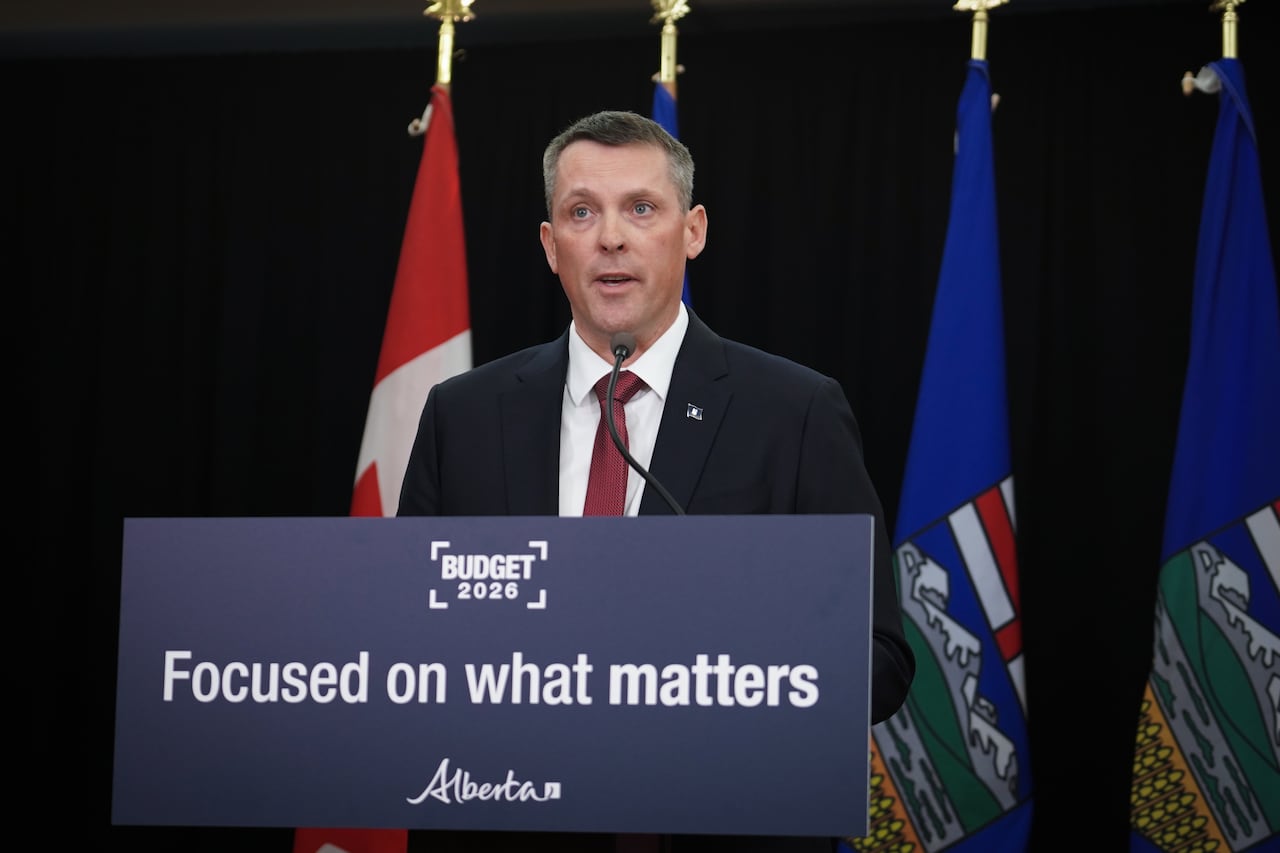 A man speaks at a podium that says "Focused on what matters."