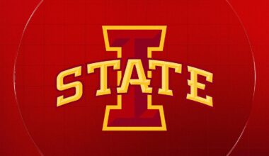 Ric and Carol Jurgens stand next to the athletics computer lab donning their name.