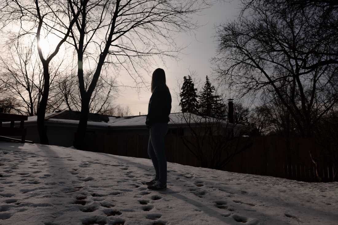 Emily poses for a portrait outside of her home, Friday, Feb. 27, 2026, in Minneapolis. During Operation Metro Surge, she began doing rapid response and was intimidated by federal immigration agents who followed her home.
