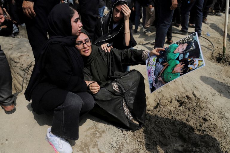 A woman holding a picture of children reacts during the funeral of the victims following a reported strike on a school, amid the U.S.-Israeli conflict with Iran, in Minab, Iran, March 3, 2026. Amirhossein Khorgooei/ISNA/WANA (West Asia News Agency) via REUTERS ATTENTION EDITORS - THIS PICTURE WAS PROVIDED BY A THIRD PARTY. TPX IMAGES OF THE DAY REFILE – REMOVING ATTRIBUTION TO STRIKE