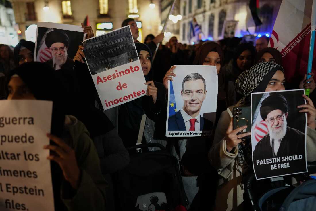 Demonstrators hold photographs of the killed Iranian supreme leader and Spanish Prime Minister Pedro Sánchez during a protest against U.S. and Israeli military attacks in Iran in Barcelona, Spain, on Wednesday.