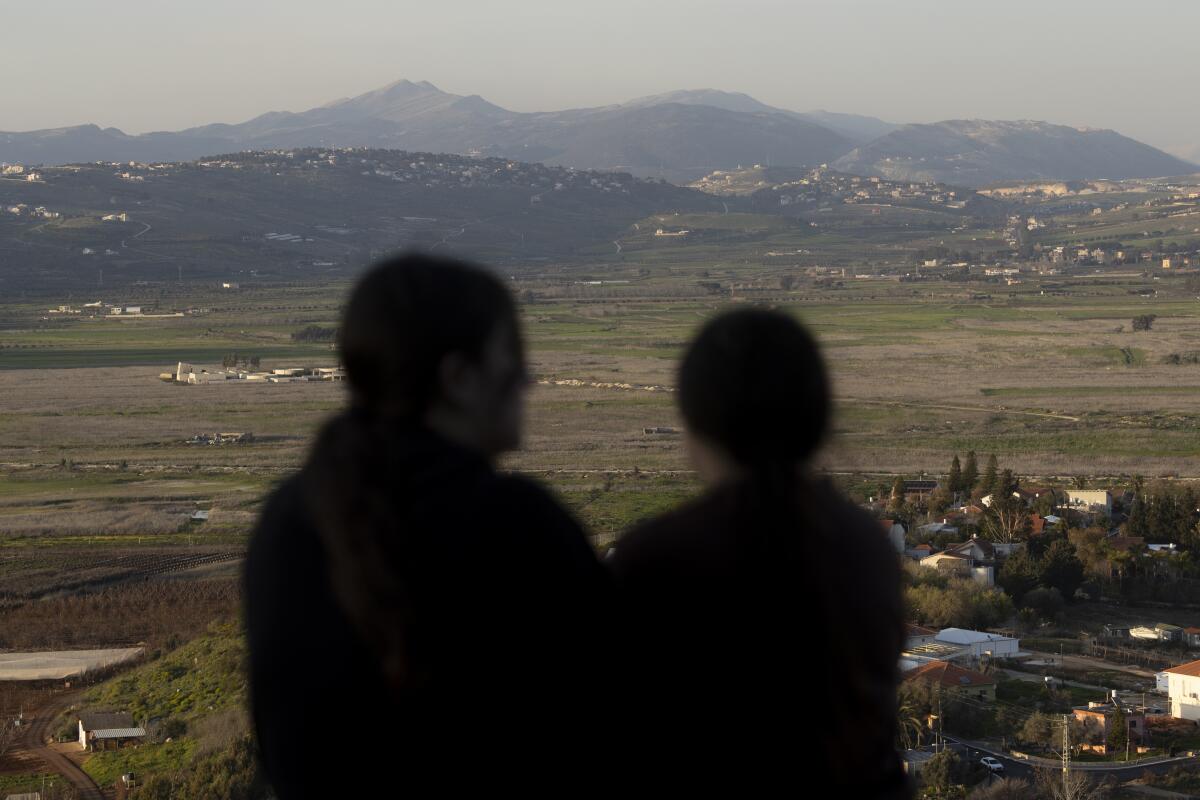 Israelis look at the border with Lebanon from a position in the northern village of Metula
