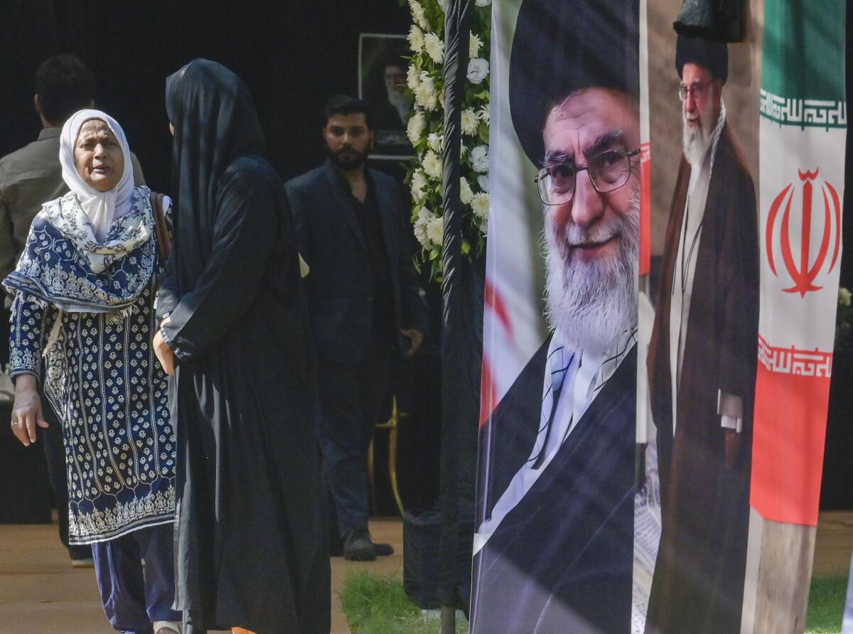 People arrive to sign a condolence book in memory of Iran's Supreme Leader Ayatollah Ali Khamenei