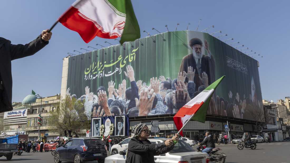 People wave flags in mourning of the slain Ayatollah Ali Khamenei during the U.S.-Israeli military campaign in Tehran, Iran, on Wednesday. The Iranian authorities ultimately postponed public mourning rituals for the supreme leader.