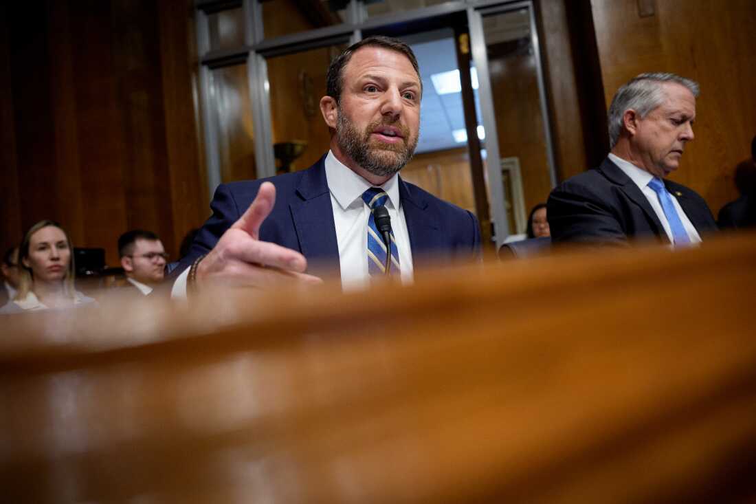Seated in front of a microphone, Senator Markwayne Mullin speaks during a Senate committee hearing last month.