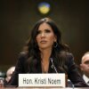 Sitting in front of a microphone, Secretary of Homeland Security Kristi Noem testifies before the Senate Judiciary Committee.