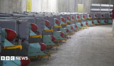 Missiles sit on trailers inside a concrete bunker.