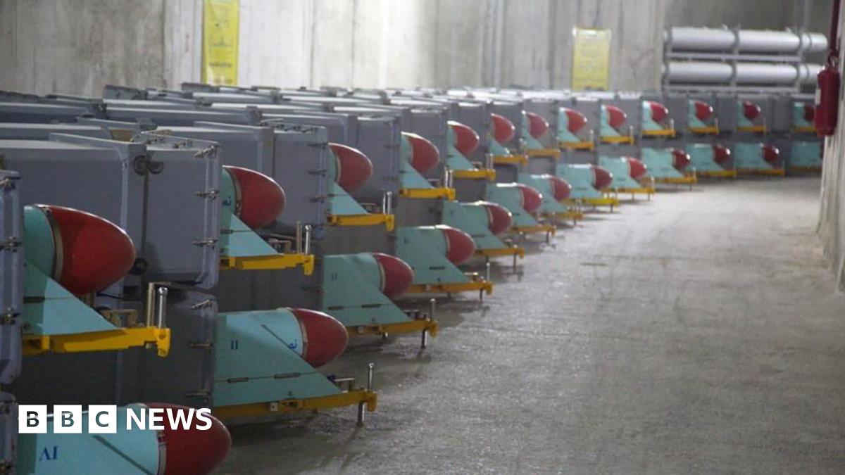 Missiles sit on trailers inside a concrete bunker.