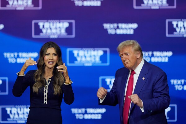 Republican presidential nominee former President Donald Trump and South Dakota Gov. Kristi Noem dance to the song "Y.M.C.A." at a campaign town hall at the Greater Philadelphia Expo Center & Fairgrounds, Oct. 14, 2024, in Oaks, Pa. (AP Photo/Matt Rourke, File)